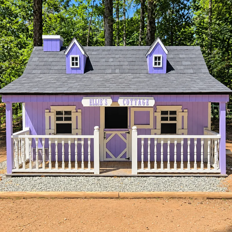 Ellie's Cottage with its purple siding, white porch rails, and cottage signs